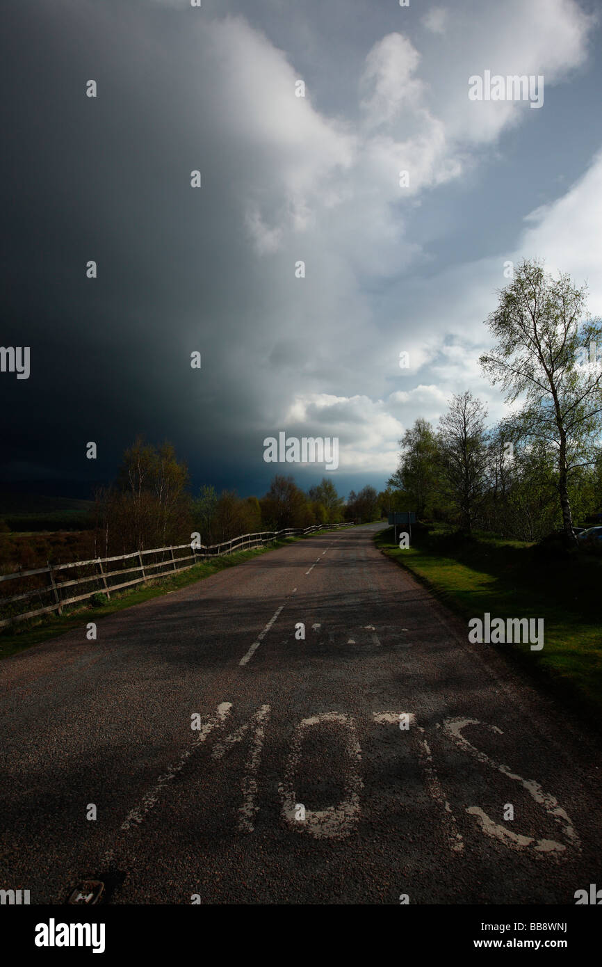 Scottish road side with bright sunshine and stormy dark clouds Scotland Great Britain UK Stock Photo