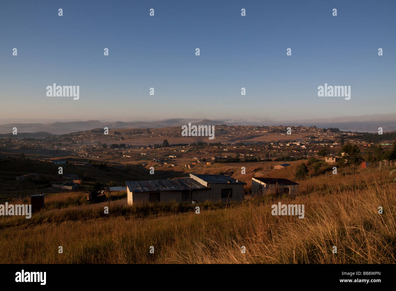 Dawn over a rural Zulu settlement in the foothills of the southern Drakensberg, Kwazulu Natal, South Africa. Stock Photo