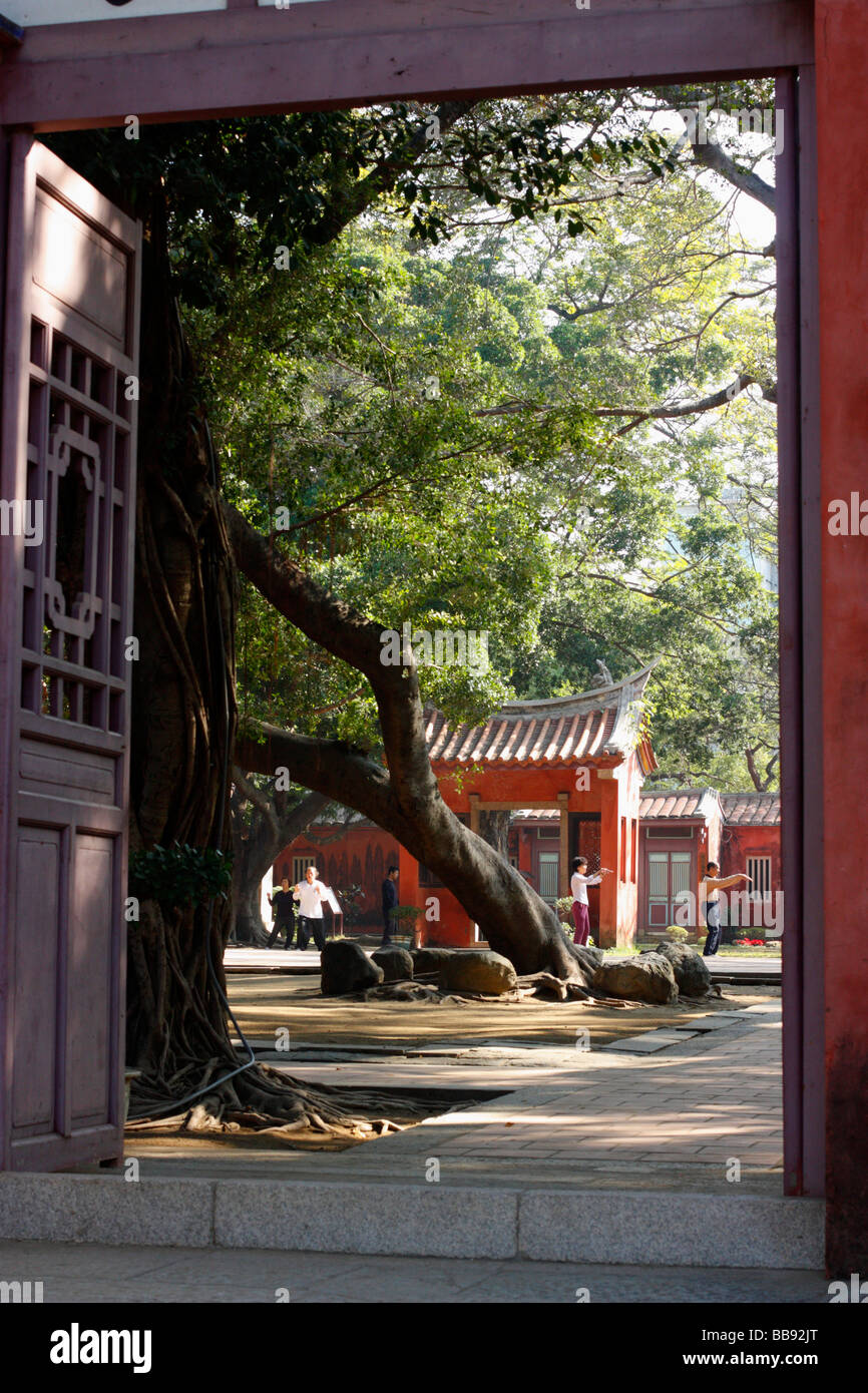 An entrance to Confucian Temple with people practicing martial arts inside. Tainan, Taiwan Stock Photo