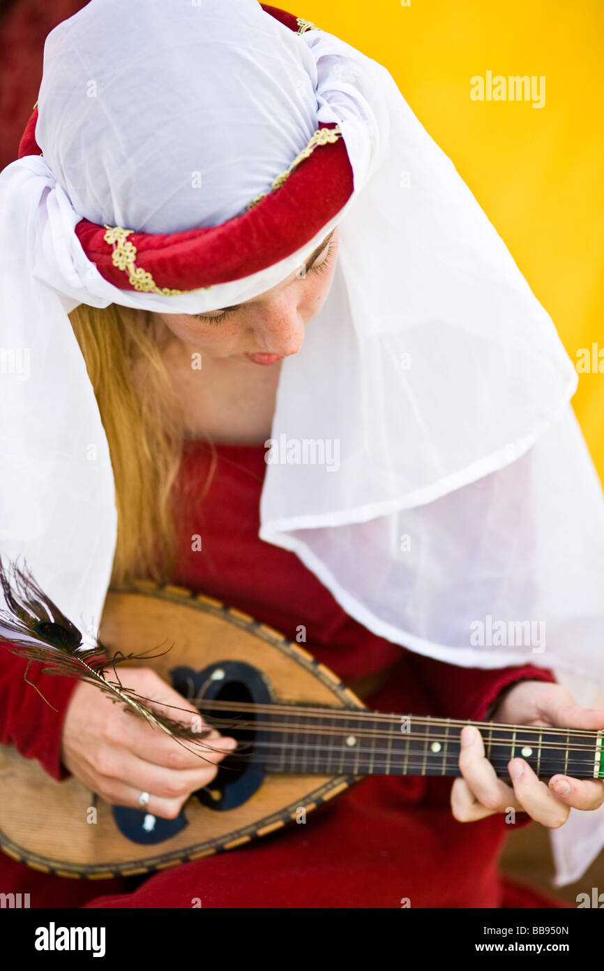 A reenactor playing a lute at a medieval reeactment, Tewkesbury, UK Stock Photo