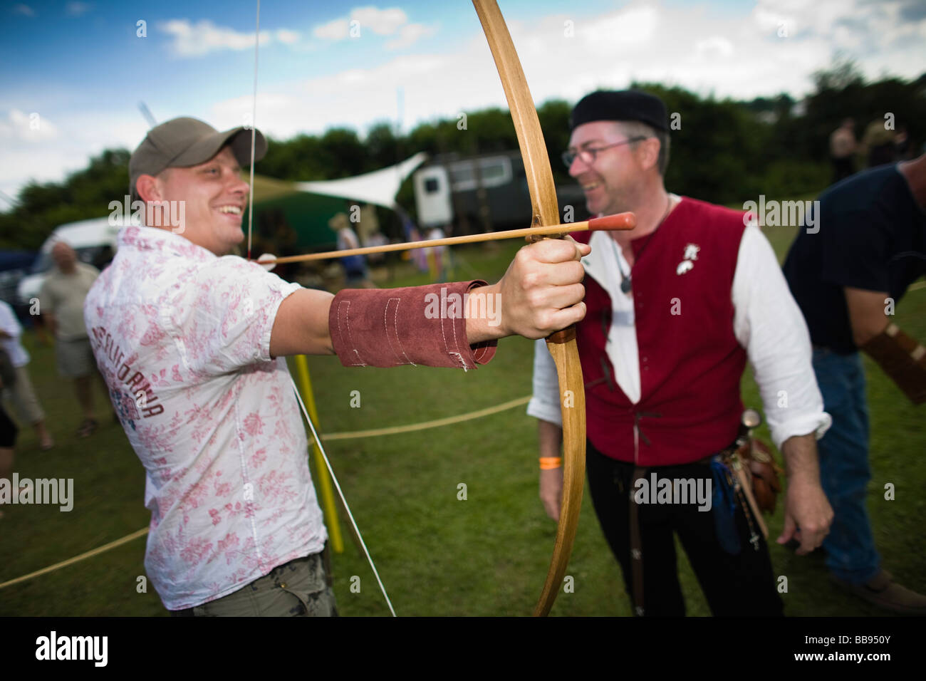 Man firing a medieval bow at Tewkesbury Medieval Festival, Gloucestershire, UK Stock Photo