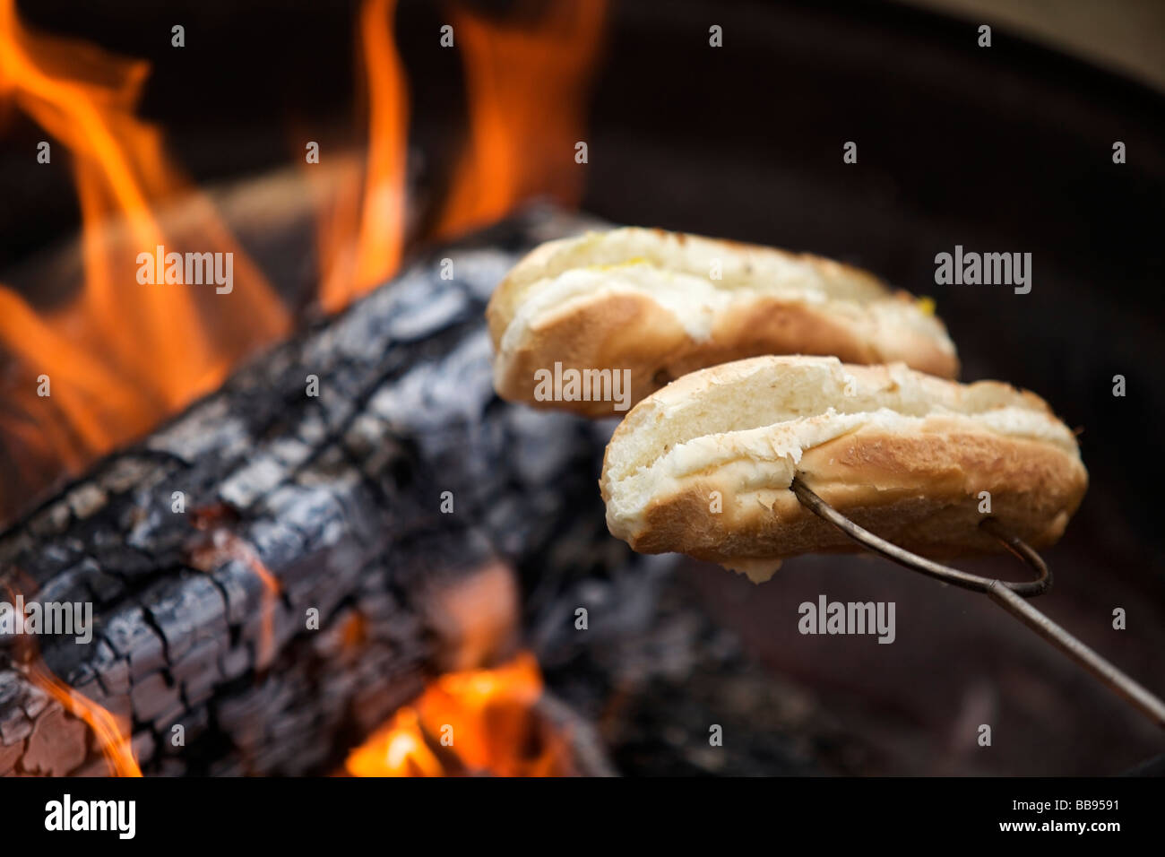 Toasting hot dog buns on a campfire Stock Photo Alamy