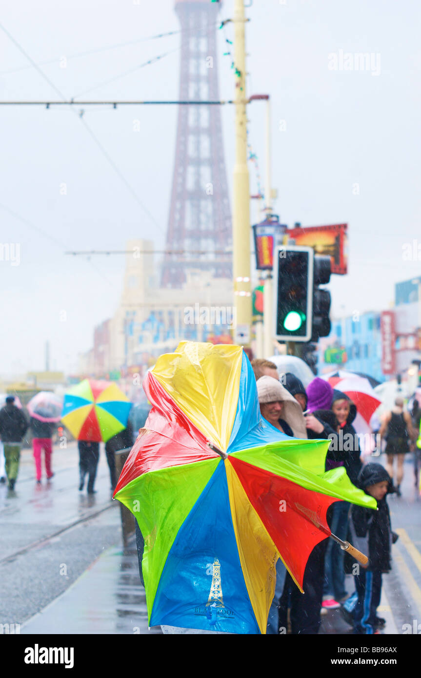 Collapsed multicolor umbrella in the wind and rain on Blackpool ...