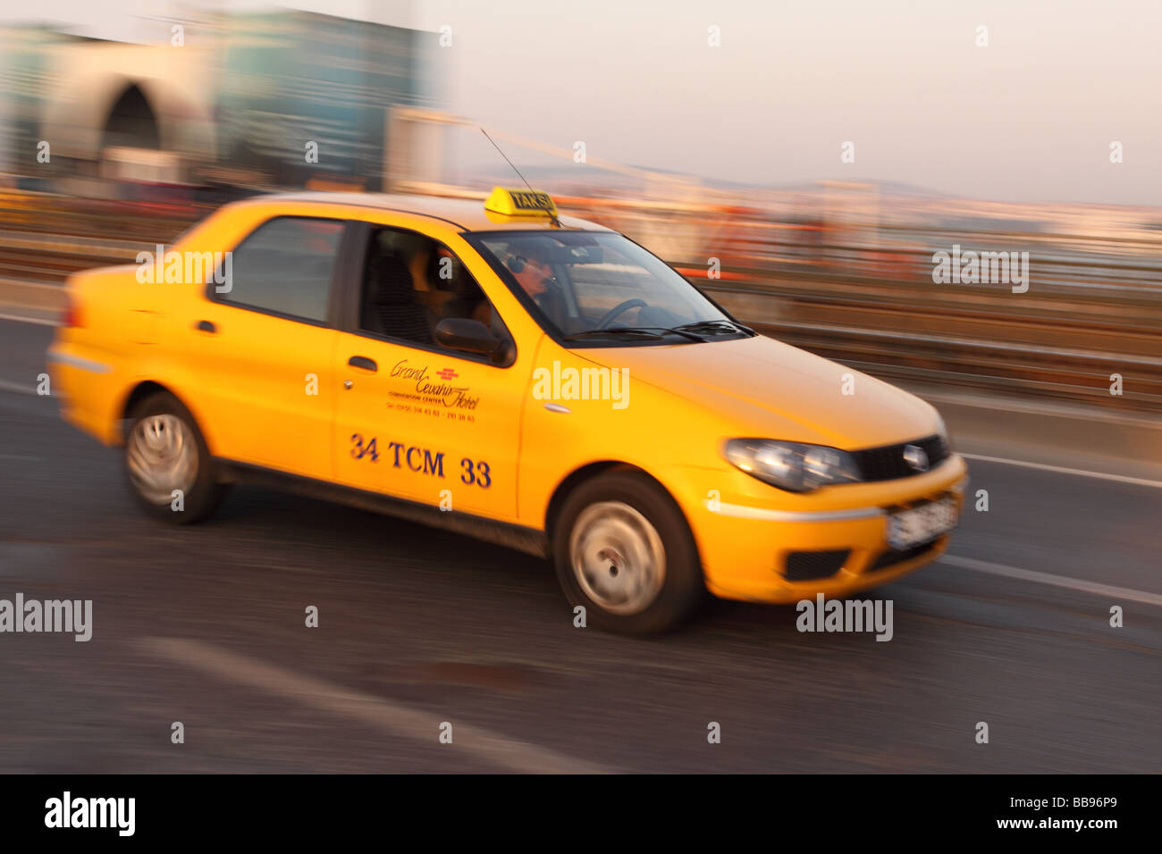 Istanbul Turkey yellow taxi cab Taksi rushes across the Galata Bridge in the evening Stock Photo