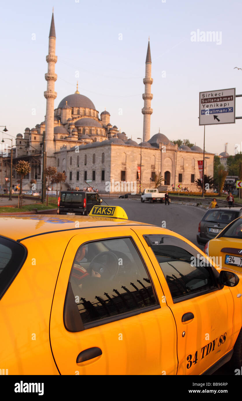Istanbul Turkey yellow taxi Taksi cab in front of the Yeni Cami New Mosque at Eminonu Stock Photo