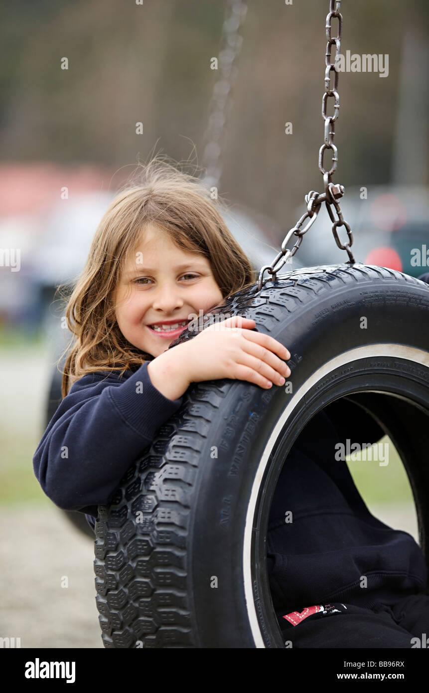 Portrait of a young girl smiling in the playground area Stock Photo - Alamy