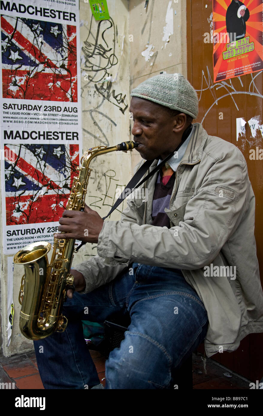Black skinned busker playing saxophone, Edinburgh, Scotland, UK, Europe Stock Photo