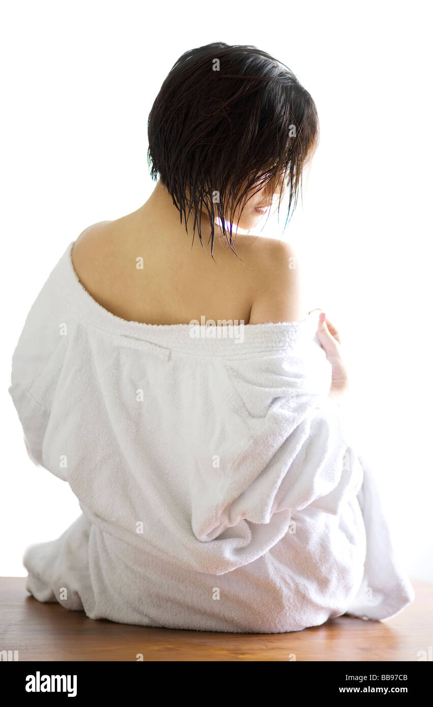 Young woman getting undressed Stock Photo
