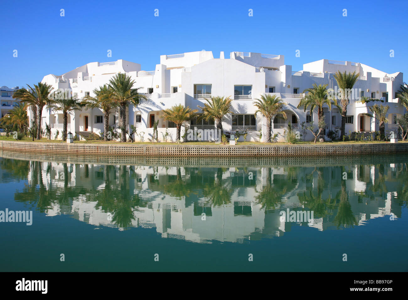 White holiday villas along a canal in Hammamet, Tunisia Stock Photo