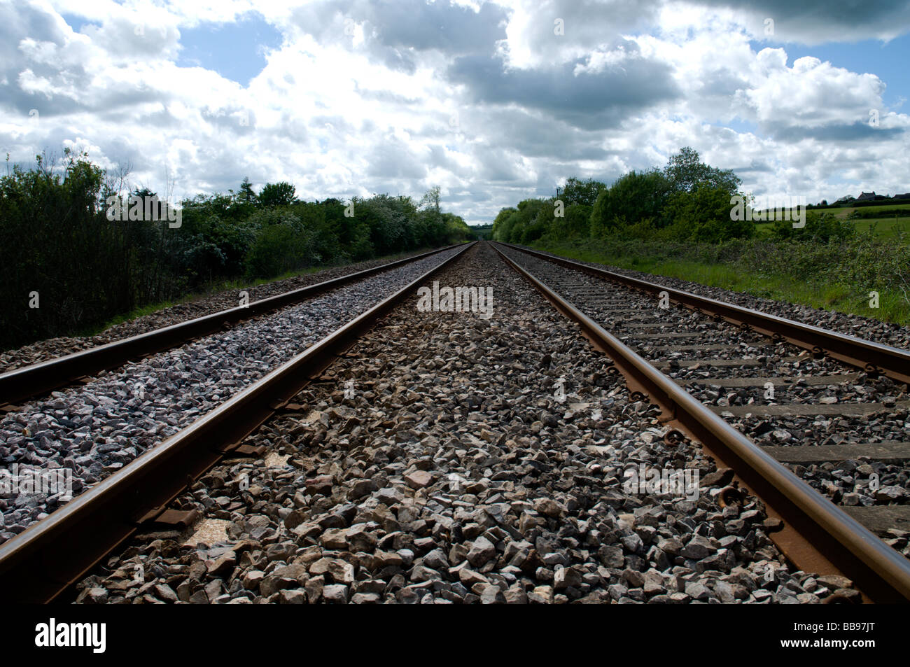 Low Perspective view of train tracks. Railway line looking down into distance. Stock Photo