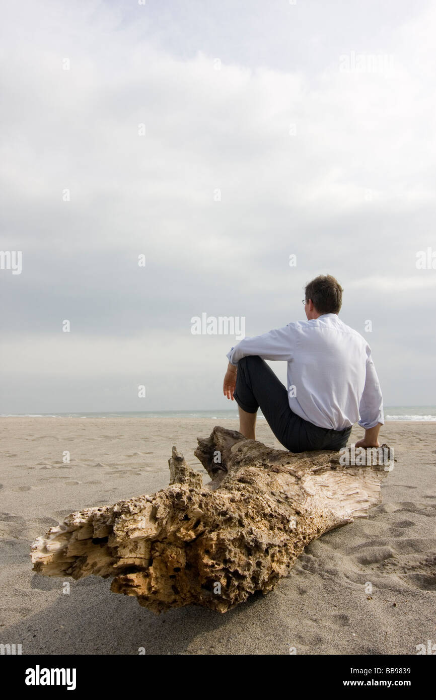Pensive man sitting on beach hi-res stock photography and images - Alamy