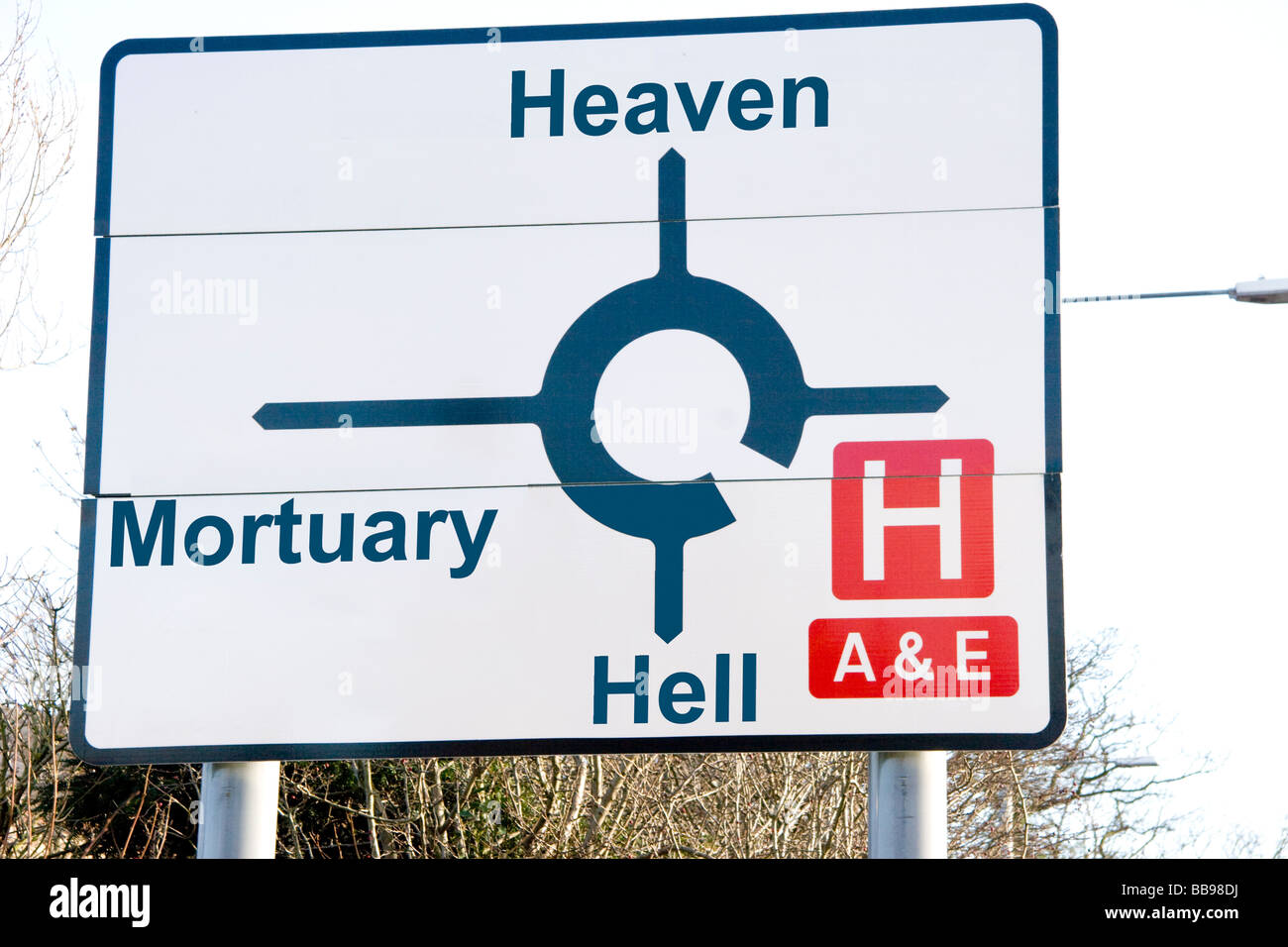 Road sign showing hospital mortuary heaven and hell Stock Photo