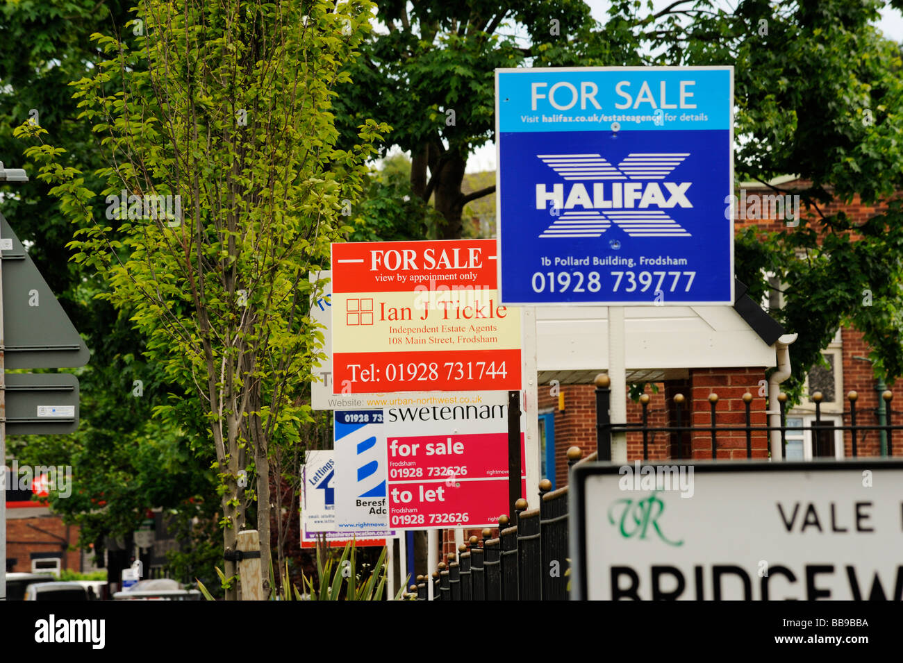 For Sale signs from various local estate agents outside a newly built