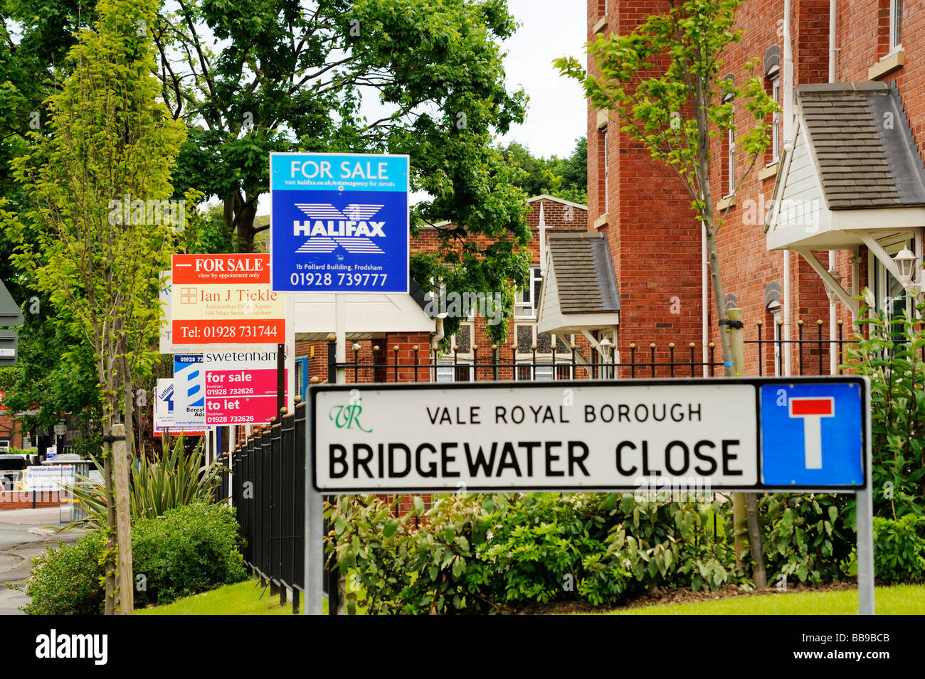 For Sale signs from various local estate agents outside a newly built