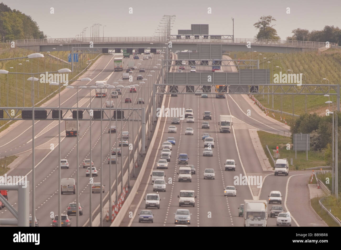 M1 motorway traffic four lanes near J9, sunny day smoggy atmosphere Stock Photo