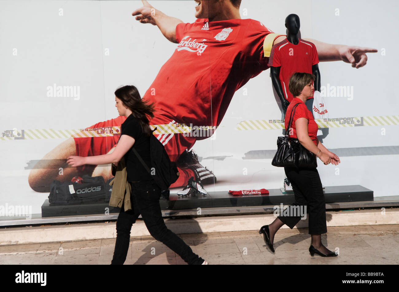Pedestrians walk past a giant Carlsberg advertisement poster in Sarajevo capital of Bosnia and Herzegovina Stock Photo