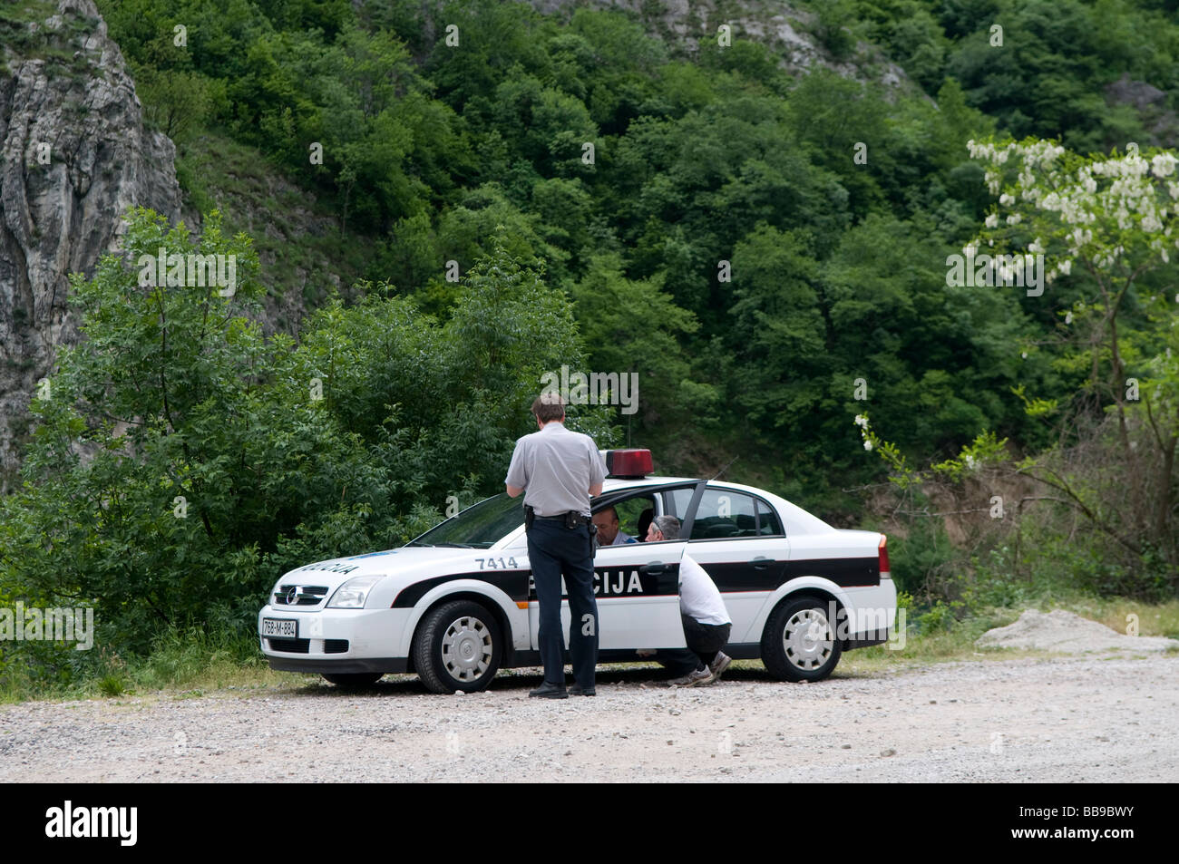 police checking documents of a driver in a police patrol car in Bosnia Herzegovina Stock Photo