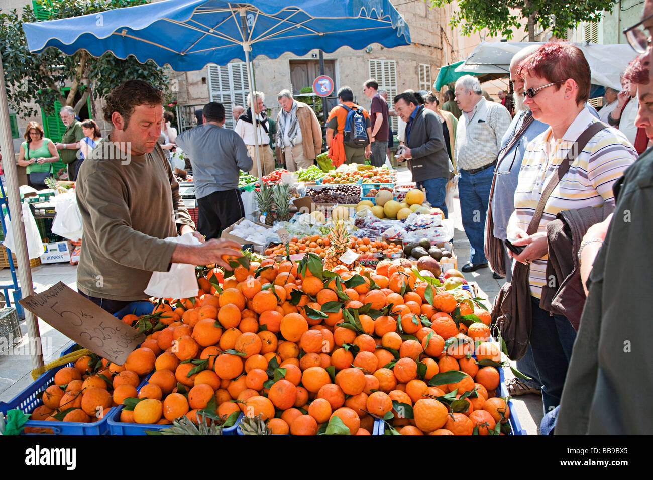 Man selling Spanish oranges in open air market Sineu Mallorca Spain Stock Photo