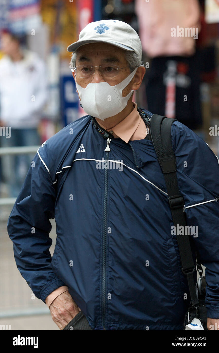 A tourist cover his face in precaution fo swine flu Stock Photo