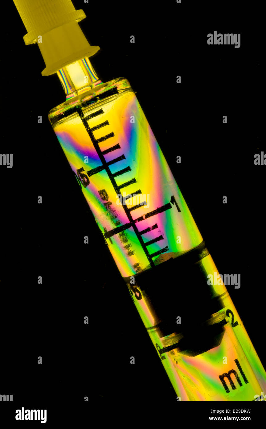 Stress patterns in plastic syringe taken in polarised light Stock Photo
