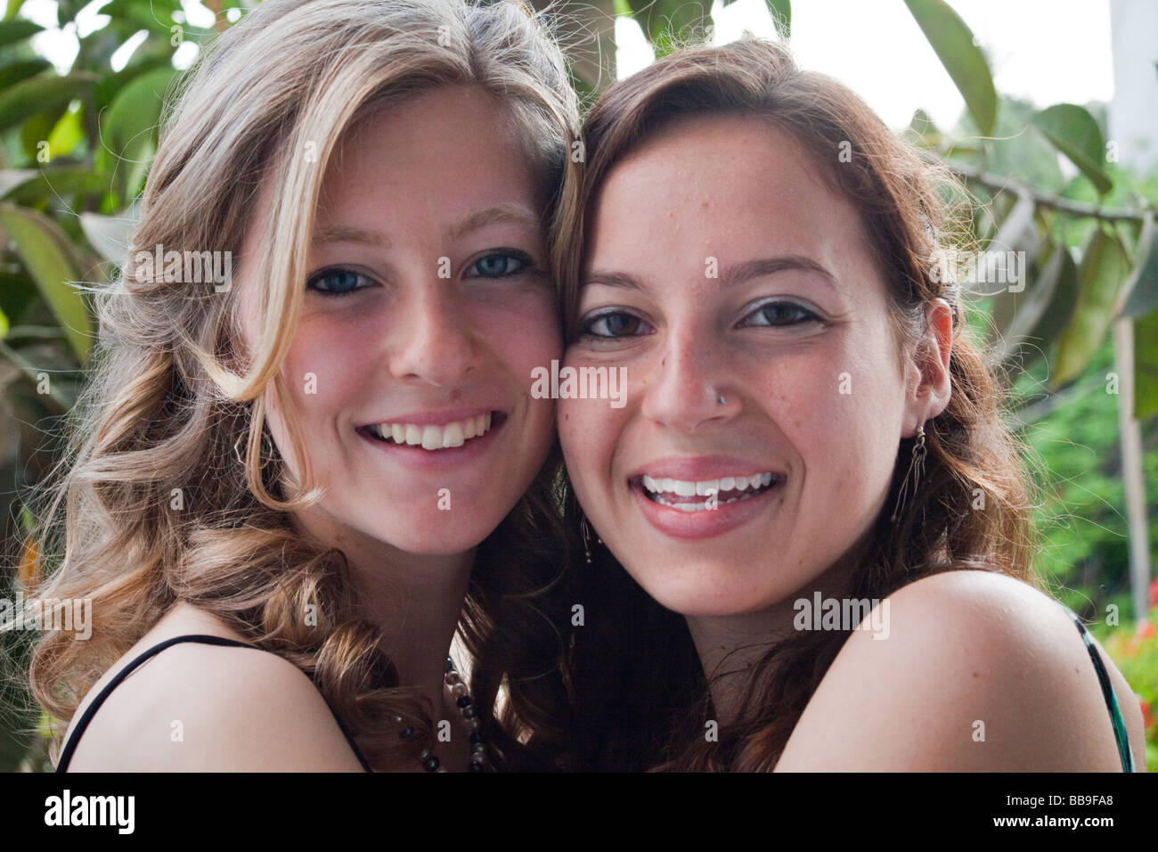 two teenage girls hugging and smiling Stock Photo - Alamy
