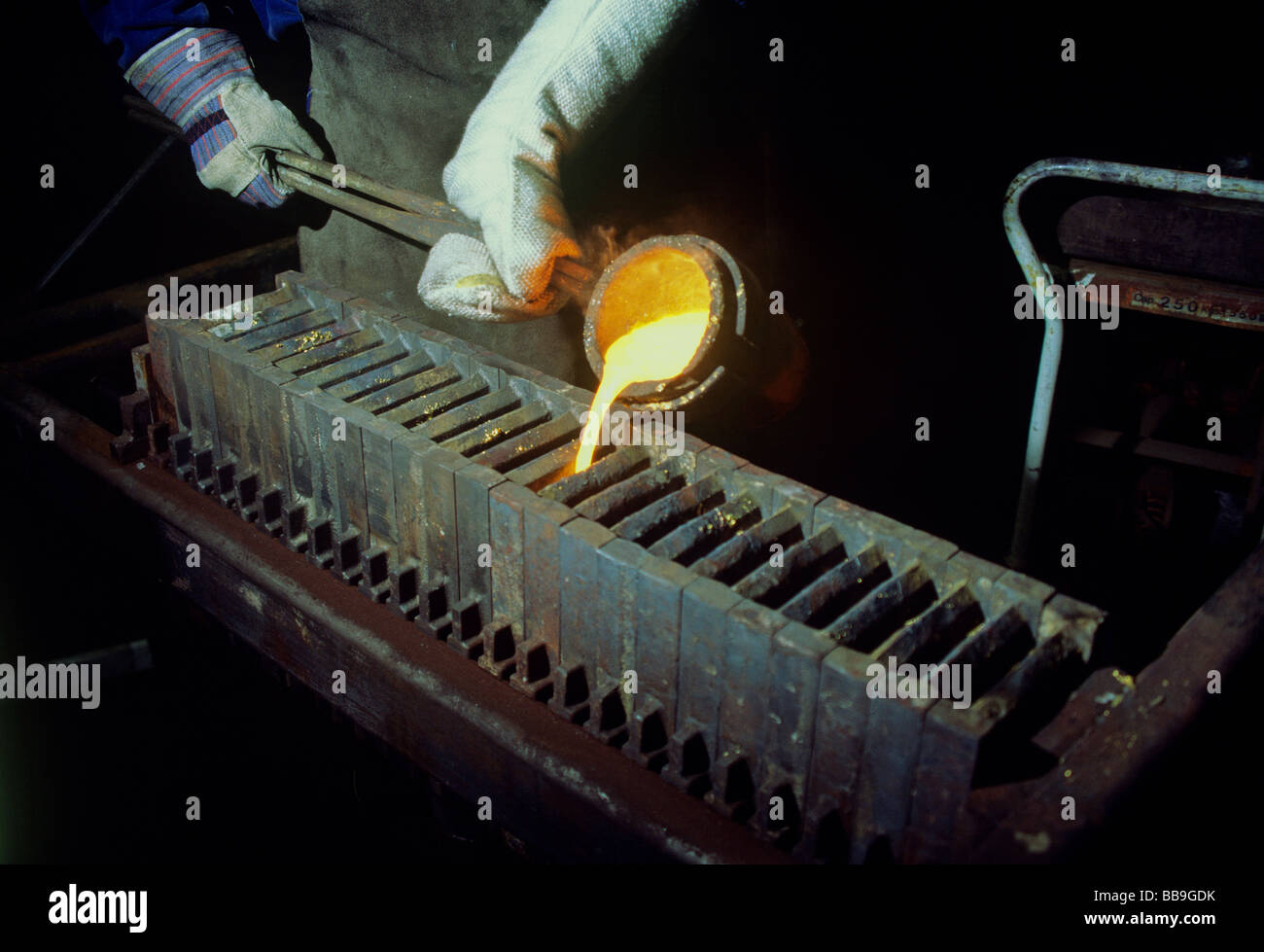 casting of unrefined gold bars foundry Stock Photo - Alamy