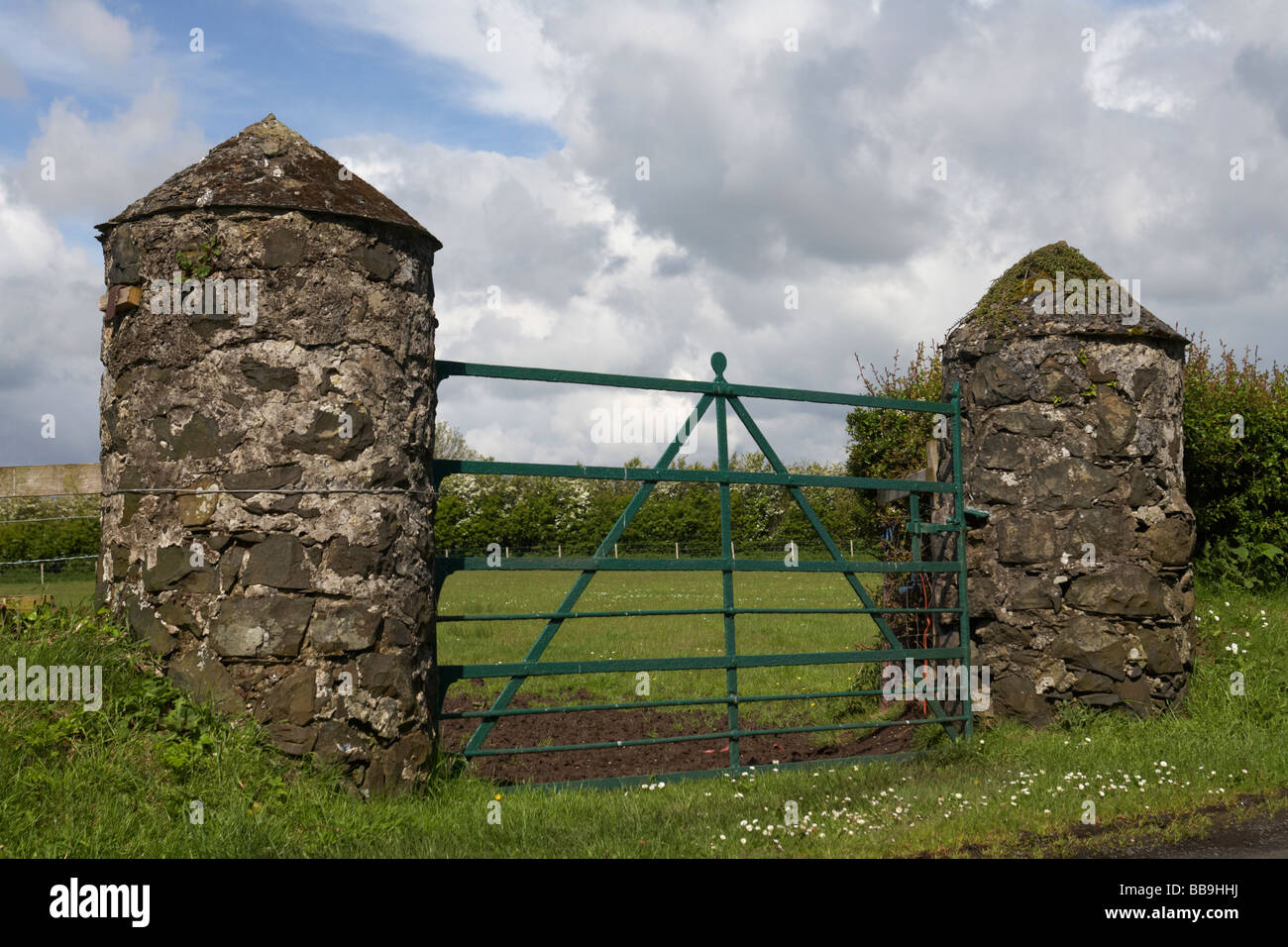traditional irish field entrance with stone pillars and wrought iron gate islandmagee county antrim northern ireland uk Stock Photo
