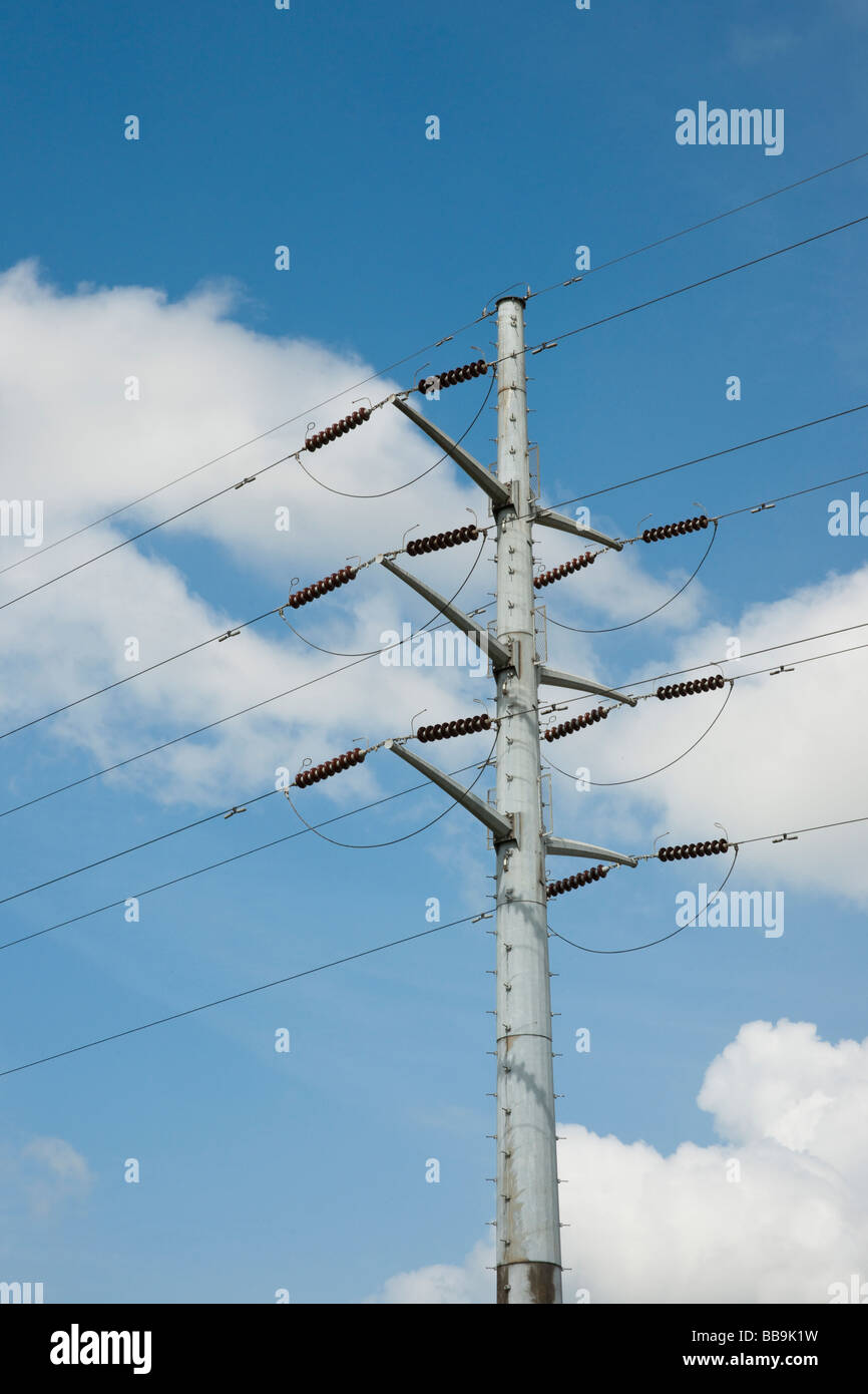 Electricity pylon and power lines against blue sky with white clouds ...