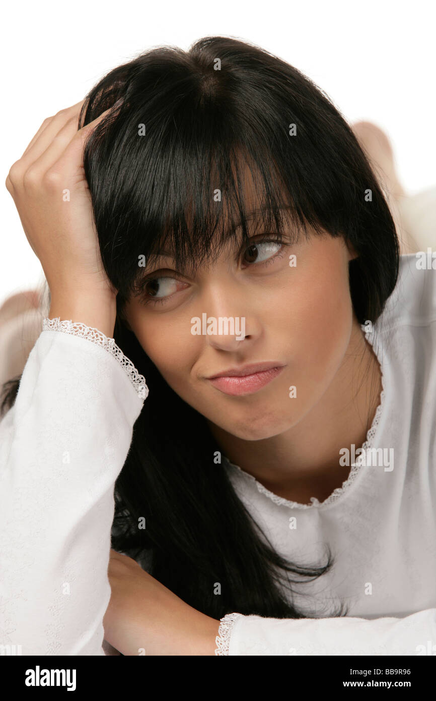 Portrait of young woman lying on bed Stock Photo