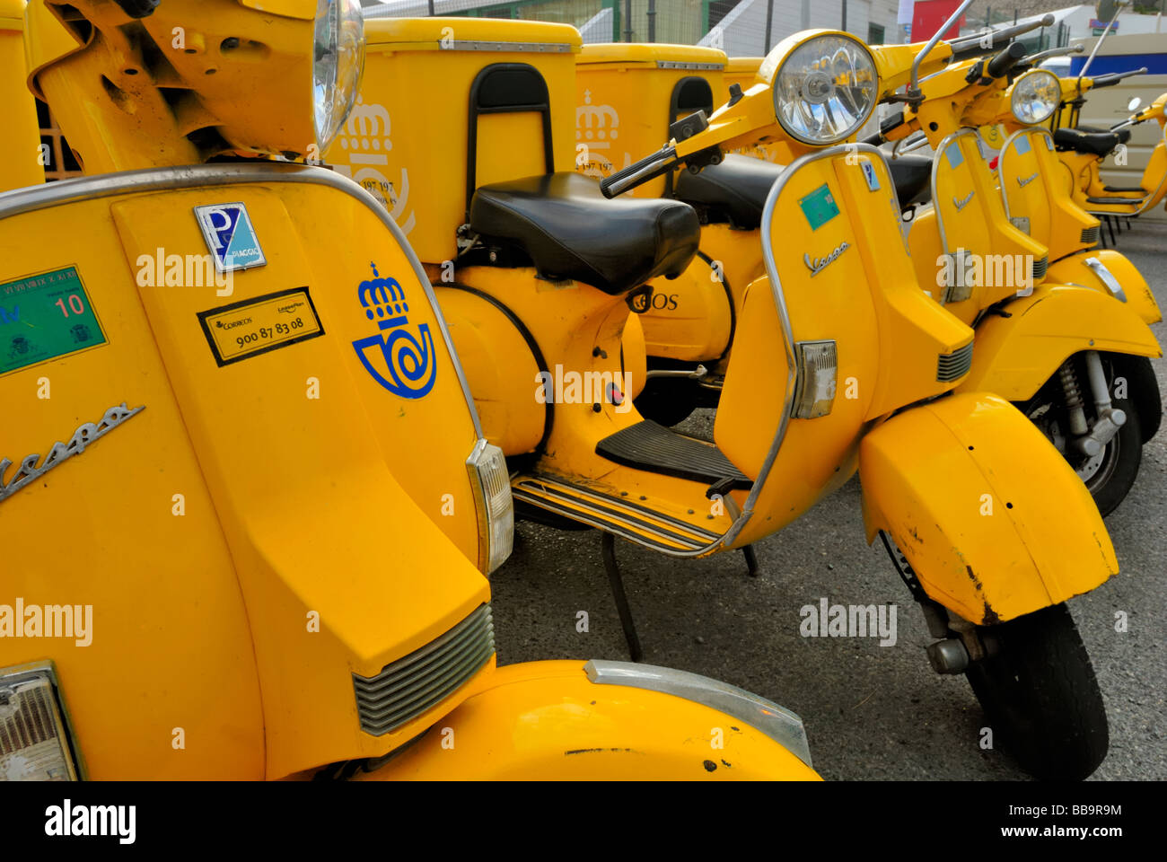 The Correos, postal service's, yellow scooters outside the Puerto Rico Post Office, Gran Canaria, Canary Island, Spain, Europe. Stock Photo