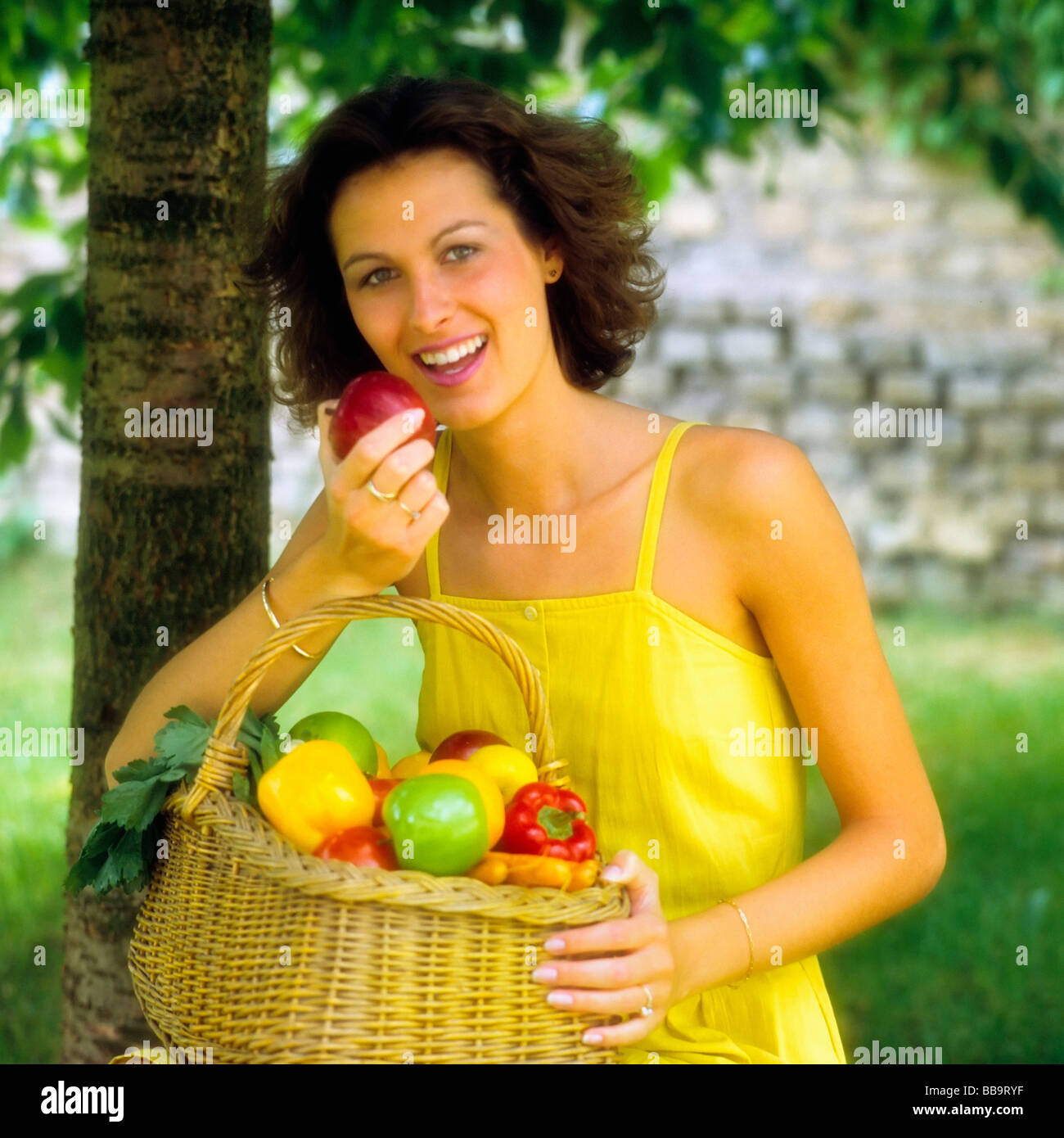 YOUNG WOMAN EATING FRUITS IN GARDEN FRANCE EUROPE Stock Photo Alamy