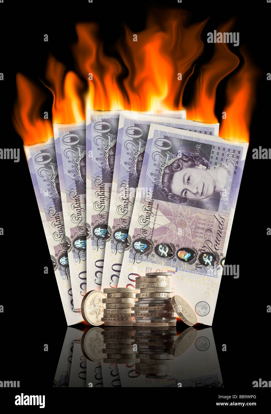 Pound notes and coins burning Stock Photo