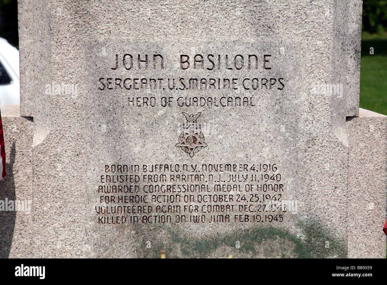 Inscription at granite base of bronze statue ofGunnery Sergeant John Basilone, war hero, WWII World War II WW2, US Marines Stock Photo