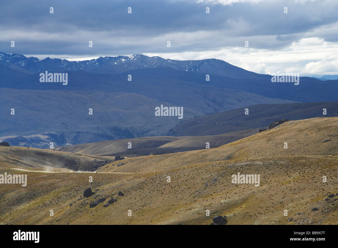 Vehicle on Nevis Road Carrick Range looking towards Nevis Valley and Hector Mountains Central Otago South Island New Zealand Stock Photo