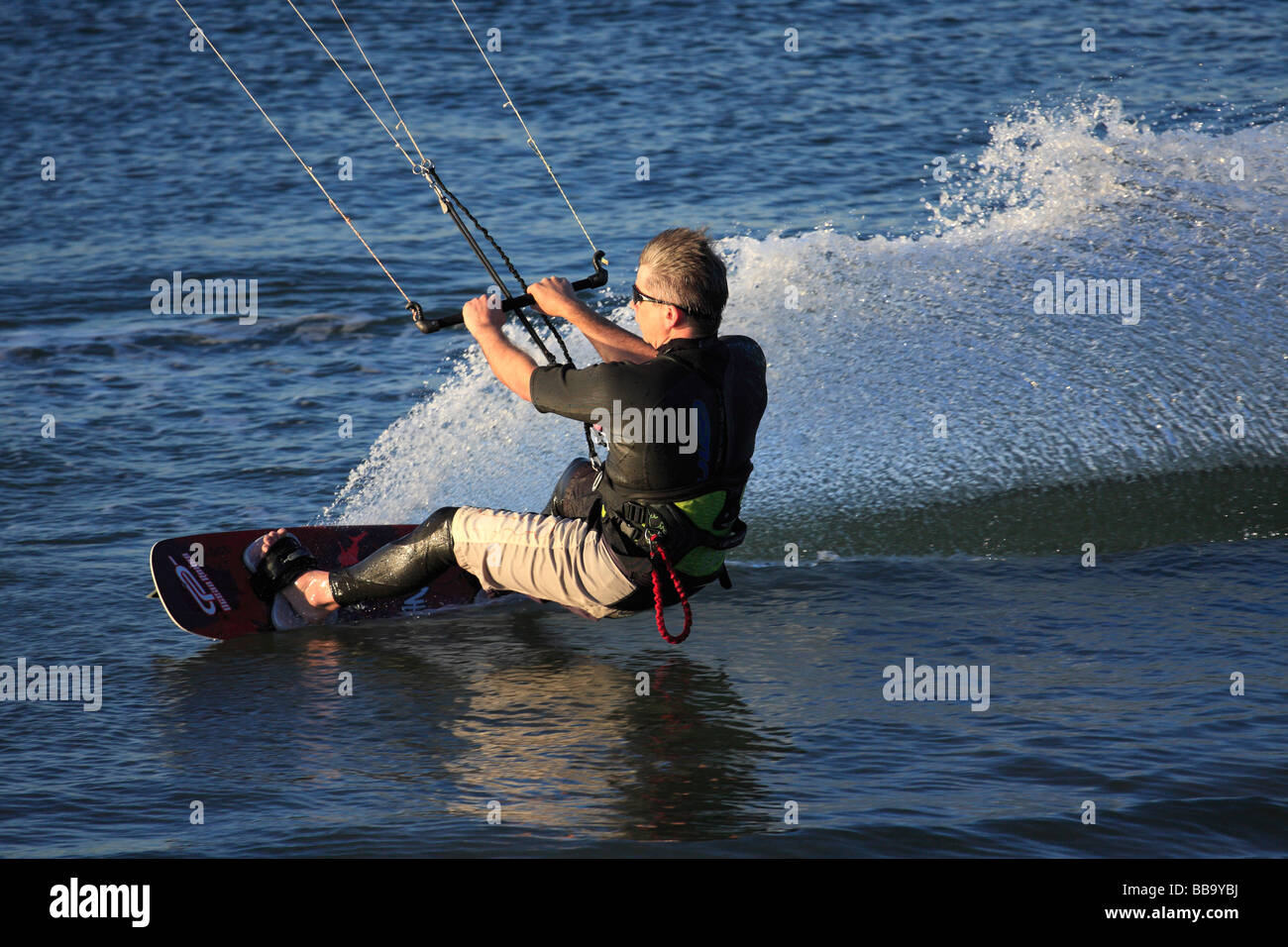 Kite Surfing. Kite Surfer creating huge wake as they move quickly atop