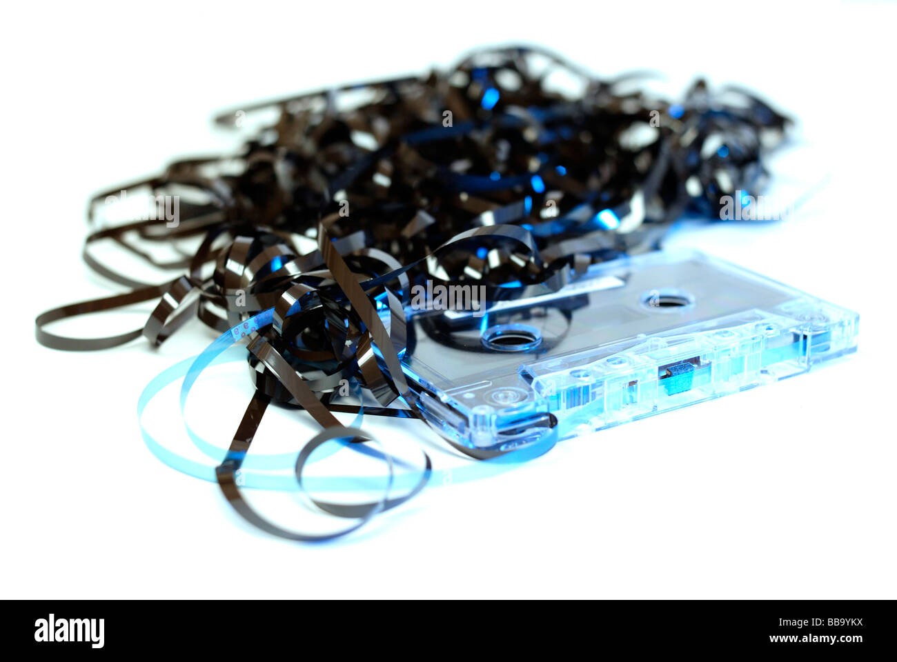 Unspooled and tangled audio cassette tape vintage retro technology. Stock Photo