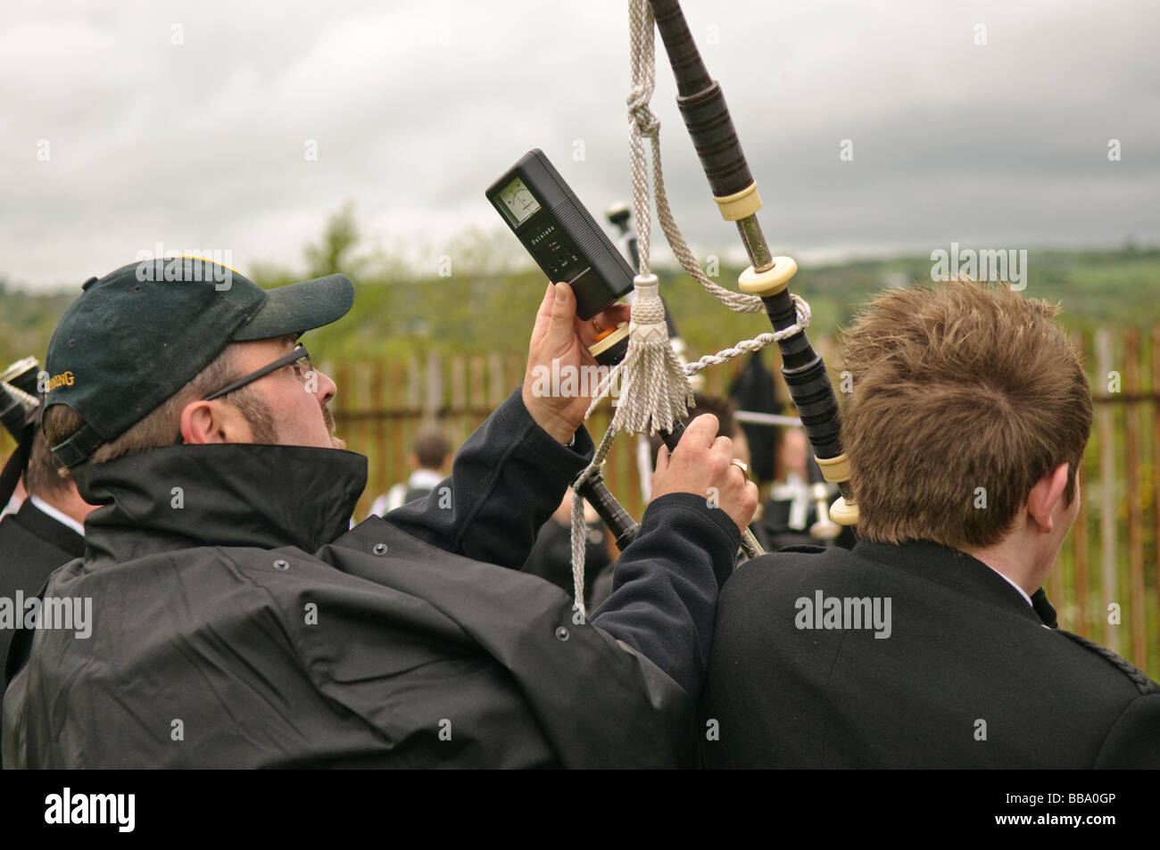 Using a digital tuning guide to tune the drones on a bagpipe at the