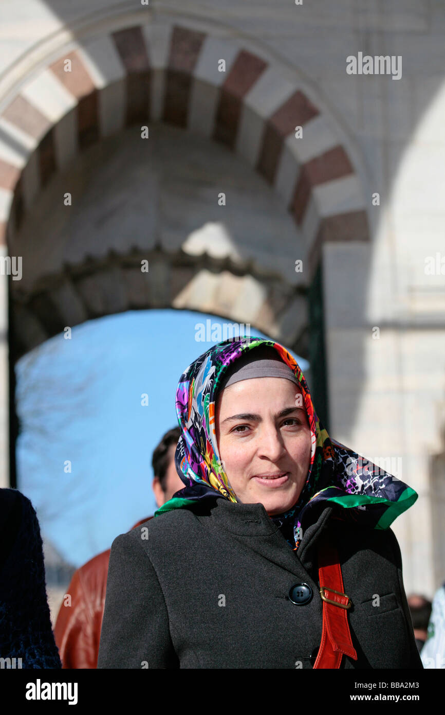 Turkish woman in a headscarf in the Blue Mosque Courtyard in Istanbul Stock Photo