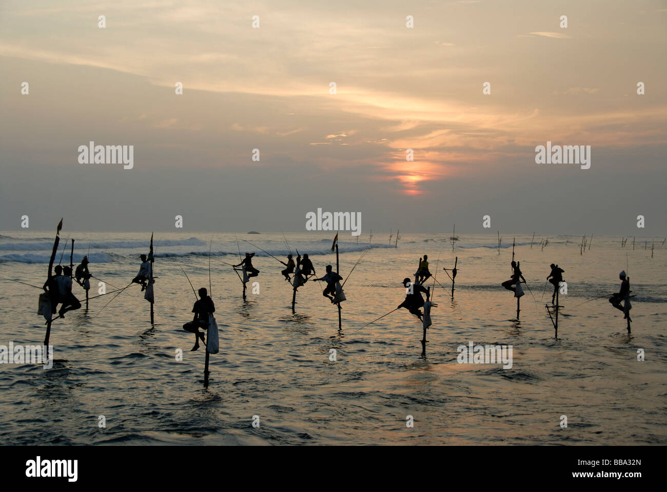 Stilt fishermen, sunset, fishermen on stilts fishing in the shallow