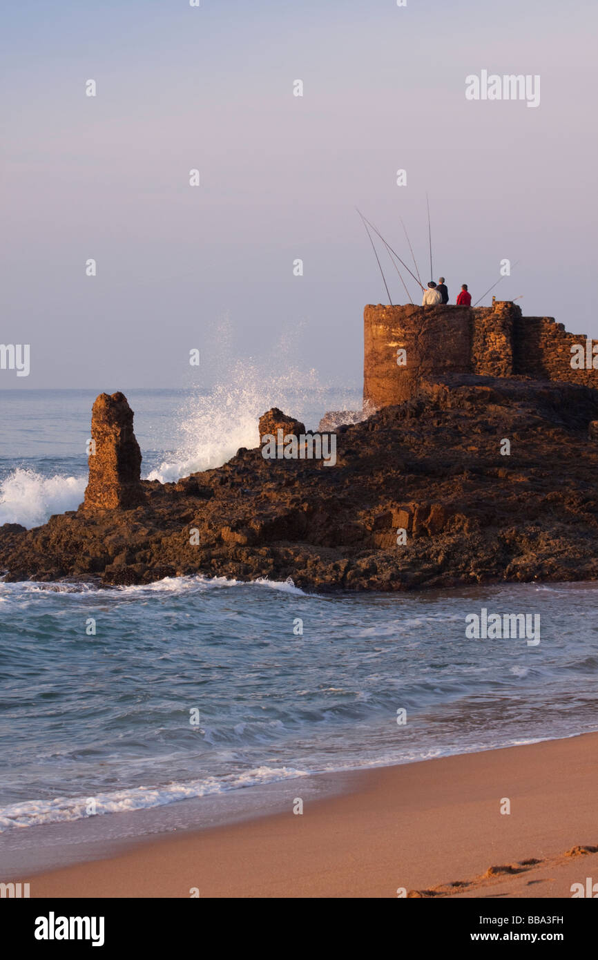 Rock fishing at first light Stock Photo