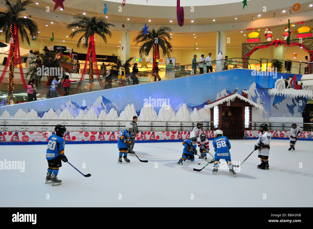 Kids playing ice hockey on the ice rink in the Al Ain Mall, Al Ain, Abu Dhabi, United Arab Emirates, Arabia, the Orient, Middle Stock Photo