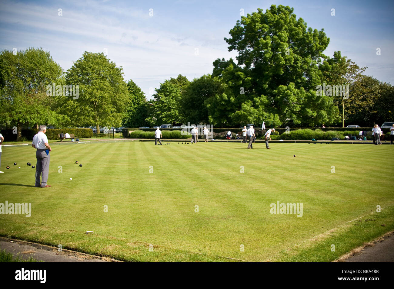 Seniors bowling on a bowling green in summer Stock Photo