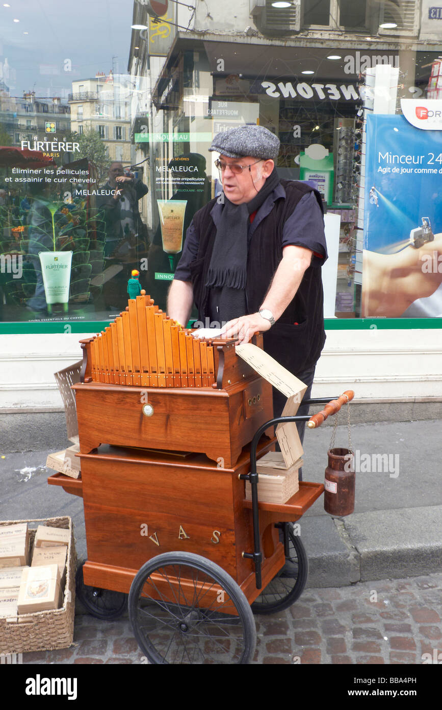 A street organ grinder in the Rue Mouffetard Paris Stock Photo
