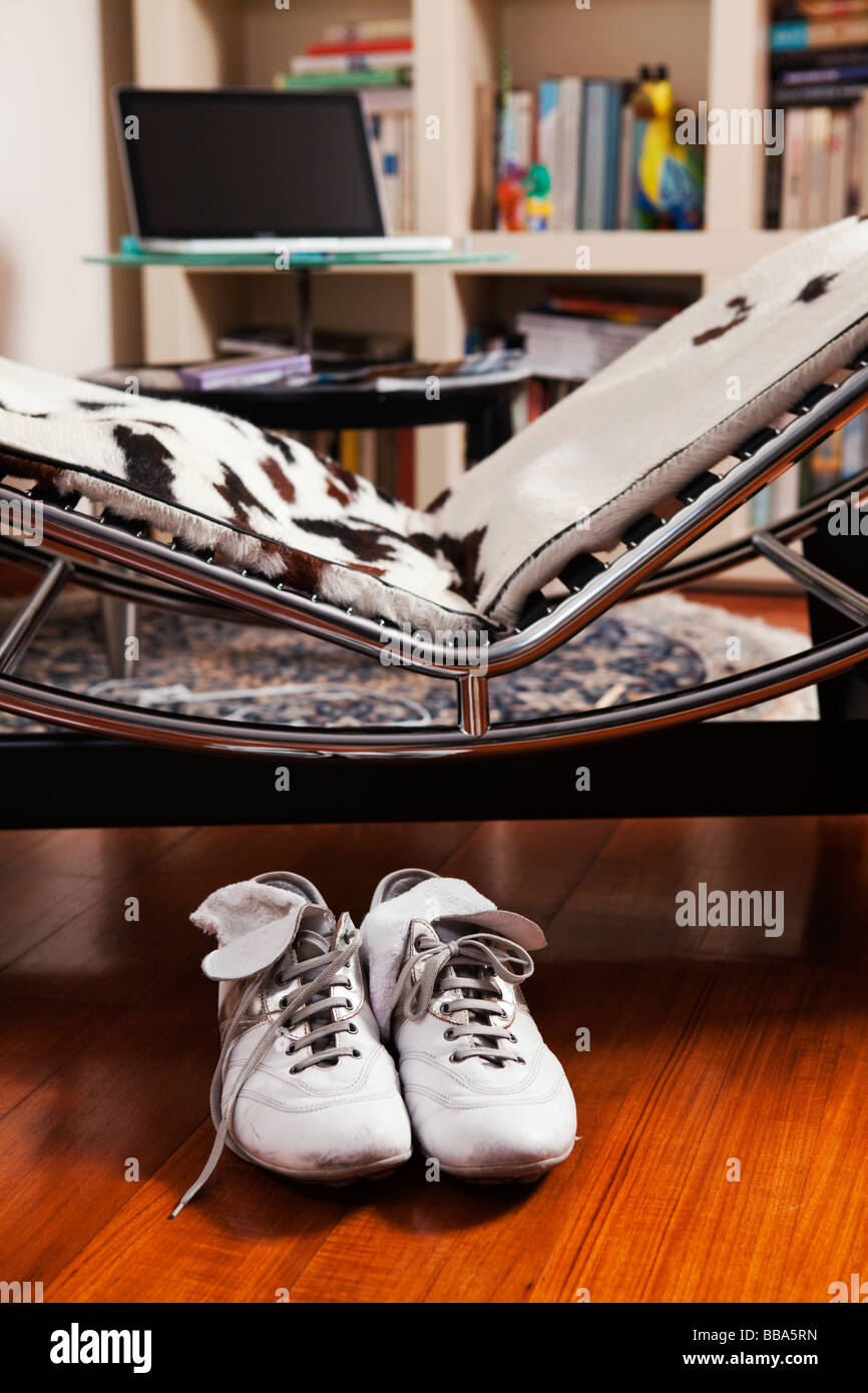Home relax. Leather shoes with socks in front of a dormeuse Stock Photo Alamy