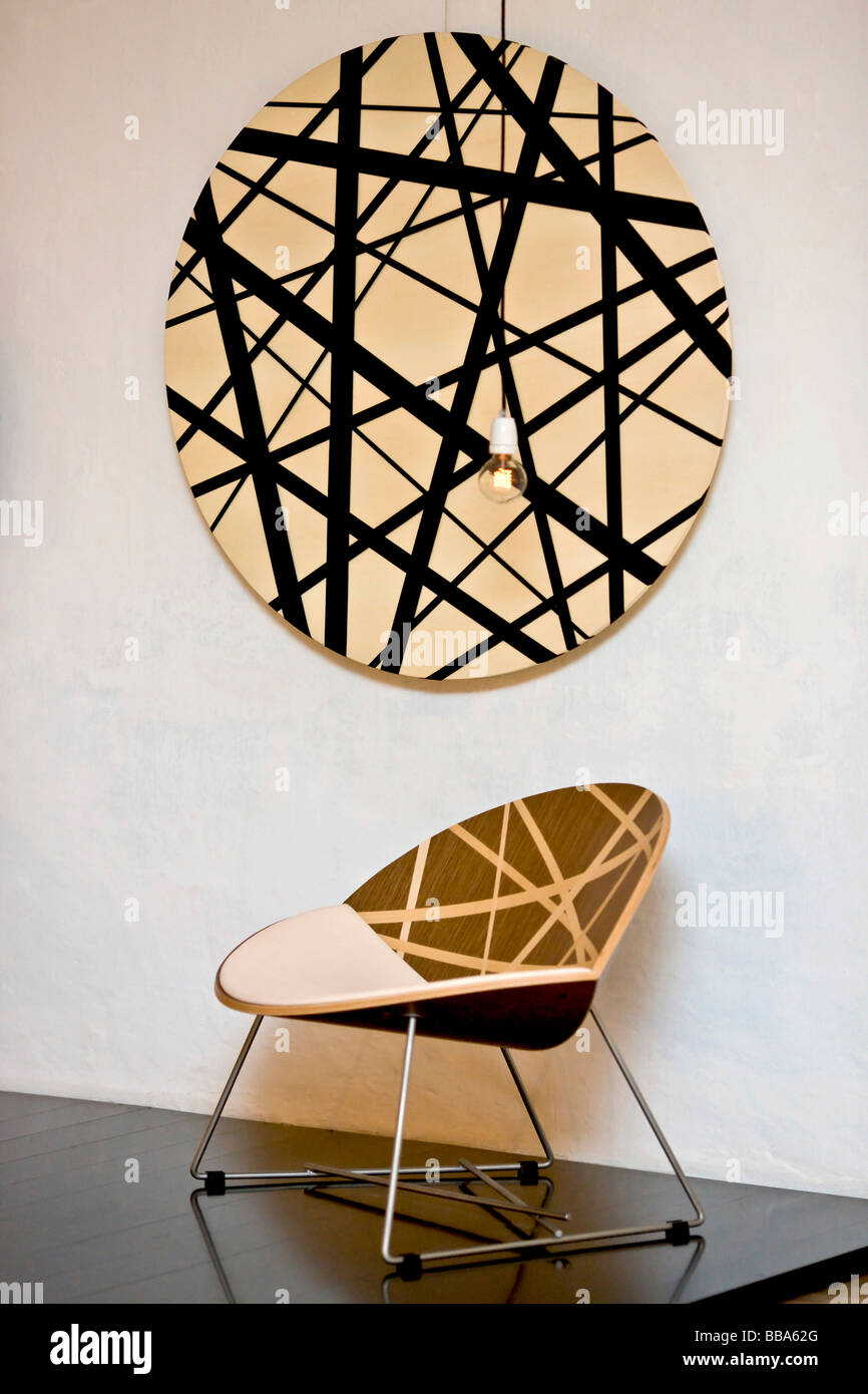 Modern designer chair and wall art Stock Photo