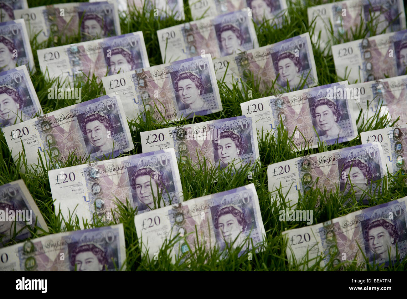 money green shoots of recovery Twenty pound notes on a green lawn finance money currency pounds sterling grass credit crunch Stock Photo