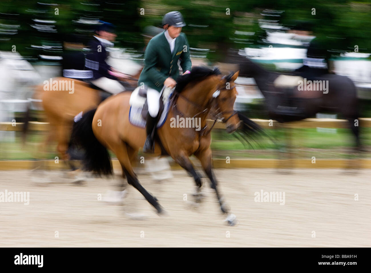 Blured image of horse riders in the practise ring of the Royal Windsor Horse Show in the grounds of Windsor Castle Stock Photo