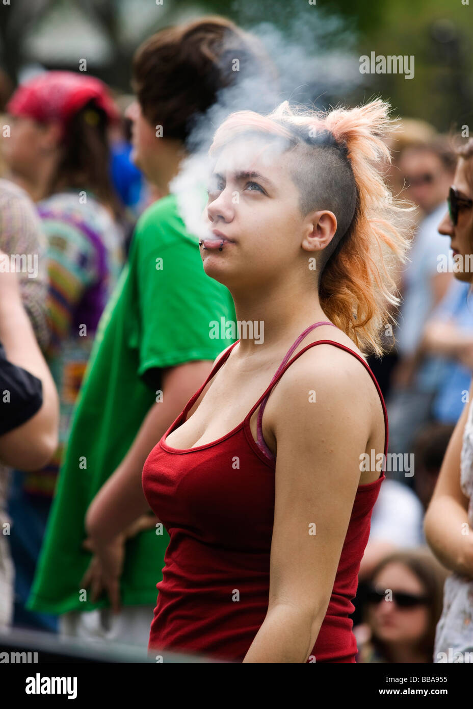 Smoking teen female with Mohawk haircut Stock Photo