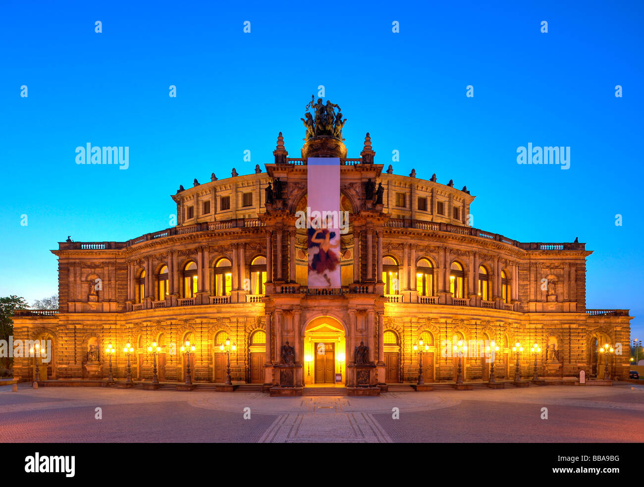 Semperoper Opera house with flags and illuminated at night, Theaterplatz square, Dresden, Free State of Saxony, Germany, Europe Stock Photo