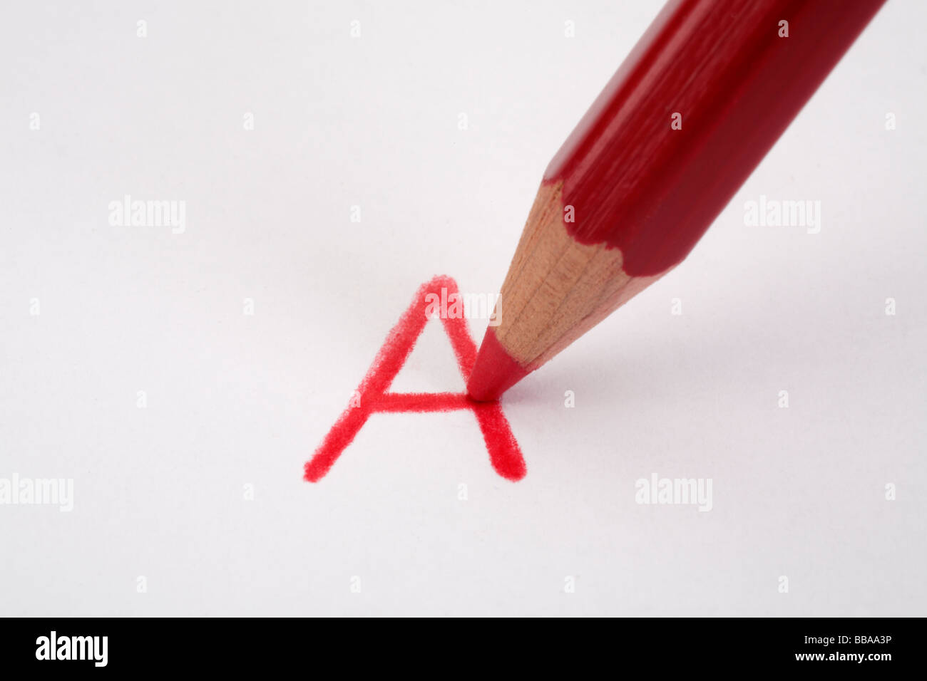 Red pencil marking an A on paper close up Stock Photo Alamy